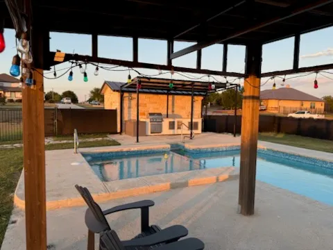 a view of a patio with a table and chairs