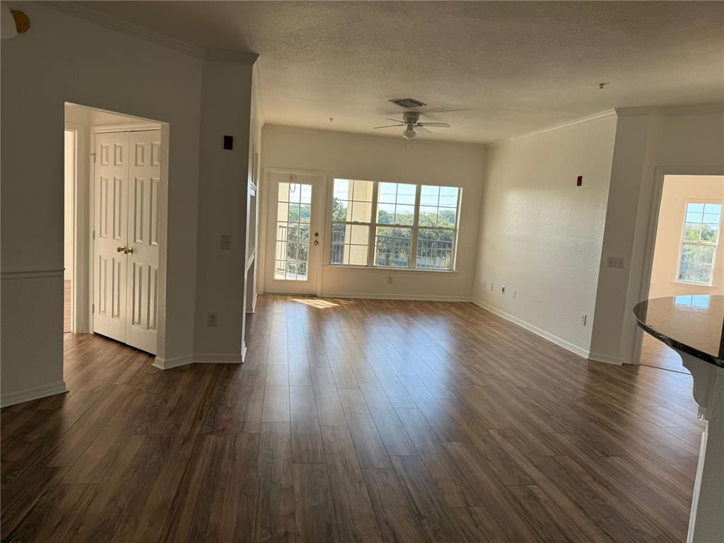 3707 Conroy Road, Unit 1731 Orlando, FL 32839 - Photo 11 of 40 an empty room with wooden floor and windows