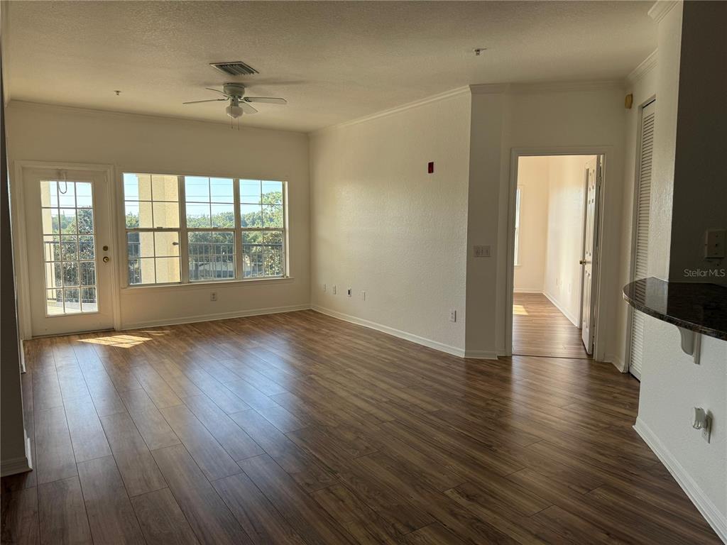 3707 Conroy Road, Unit 1731 Orlando, FL 32839 - Photo 14 of 40 an empty room with wooden floor and windows