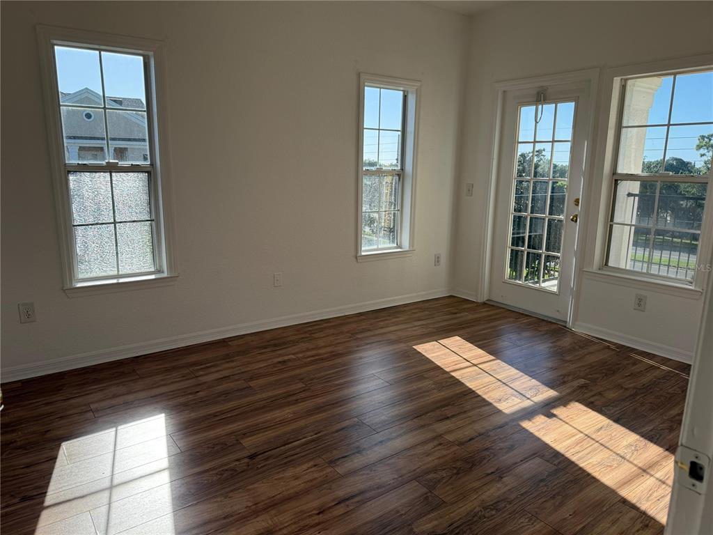3707 Conroy Road, Unit 1731 Orlando, FL 32839 - Photo 15 of 40 an empty room with wooden floor and windows