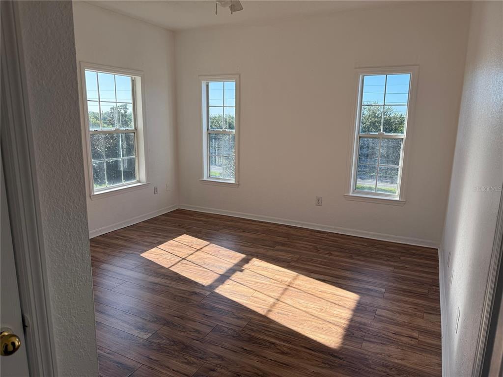 3707 Conroy Road, Unit 1731 Orlando, FL 32839 - Photo 16 of 40 a view of wooden floor and windows in a room