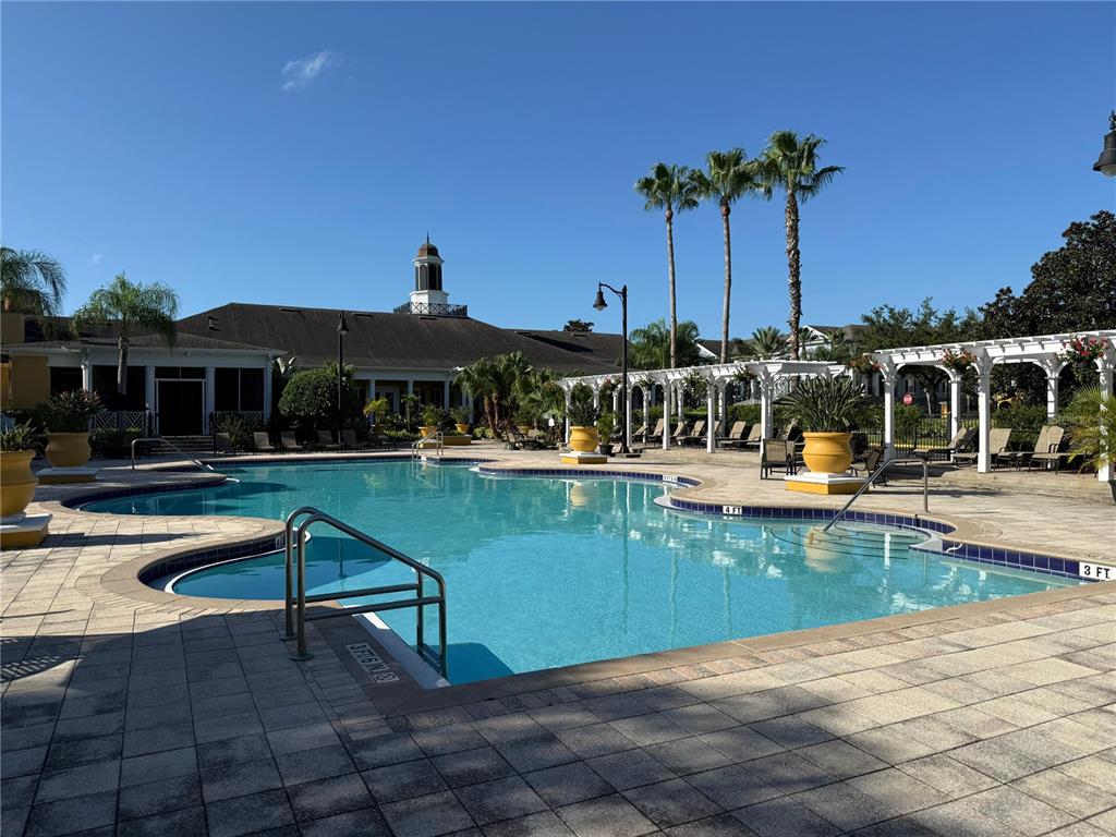 3707 Conroy Road, Unit 1731 Orlando, FL 32839 - Photo 30 of 40 a view of a swimming pool with a table and chairs