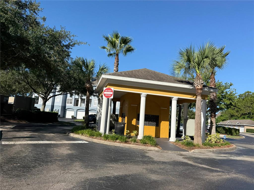 3707 Conroy Road, Unit 1731 Orlando, FL 32839 - Photo 36 of 40 a view of a brick building with a large window and palm trees