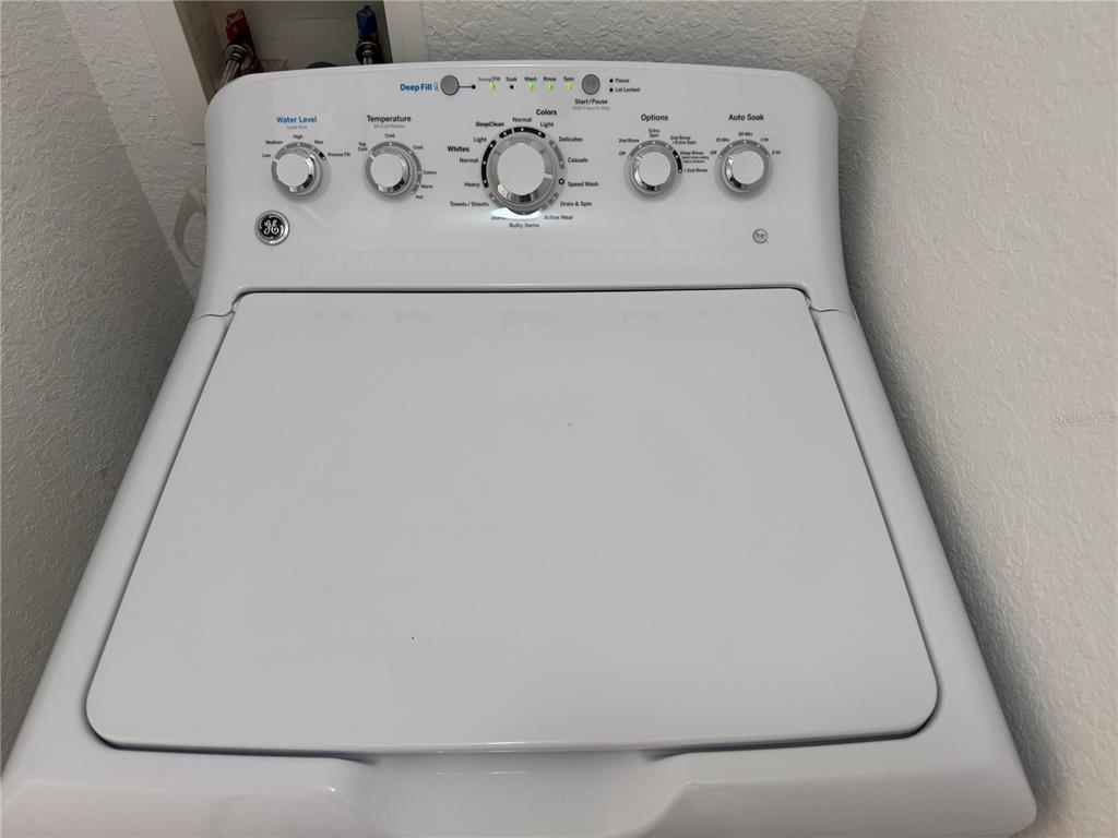 3707 Conroy Road, Unit 1731 Orlando, FL 32839 - Photo 10 of 40 view of white cabinets with washer and dryer