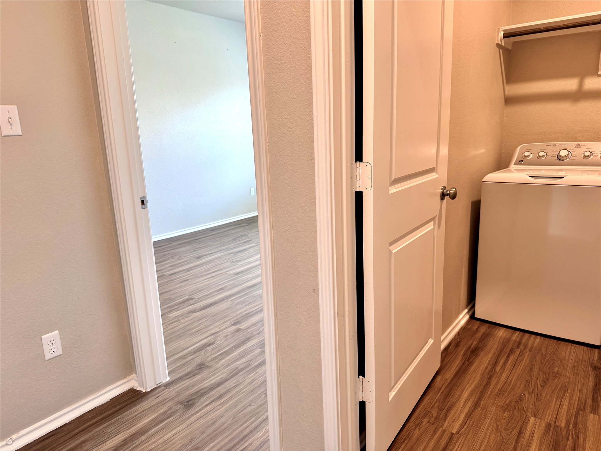 129 Perfect World Loop Jarrell, TX 76537 - Photo 13 of 31 Functional laundry space featuring a modern washer with convenient overhead shelving.