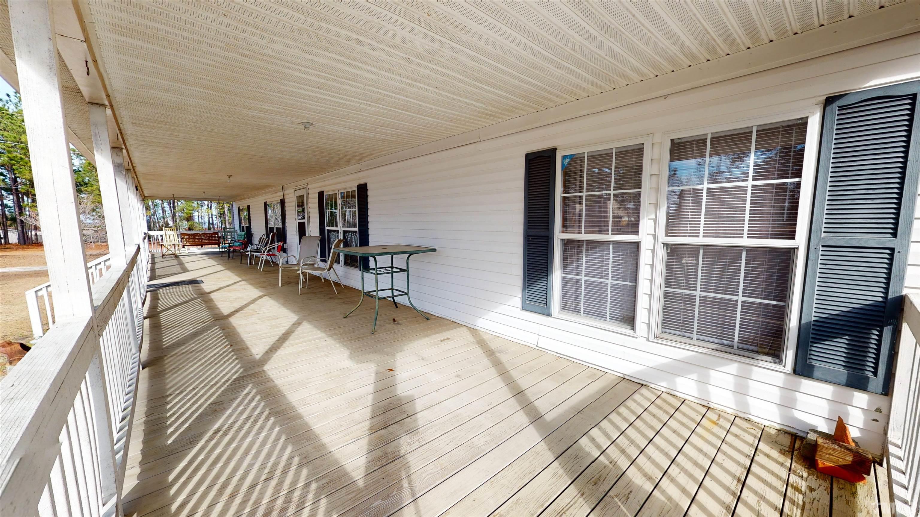 1229 Tingen Road Broadway, NC 27505 - Photo 3 of 17 a view of a bedroom with wooden floor and windows