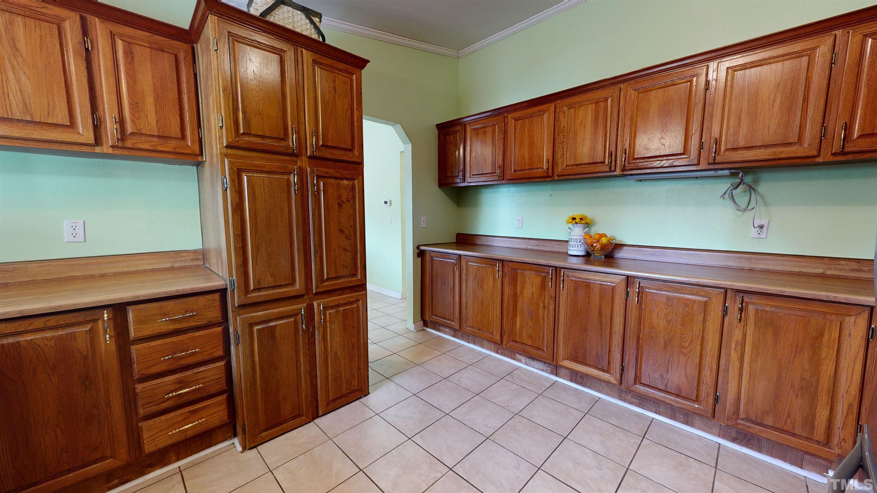 1229 Tingen Road Broadway, NC 27505 - Photo 8 of 17 a kitchen with stainless steel appliances granite countertop wood cabinets