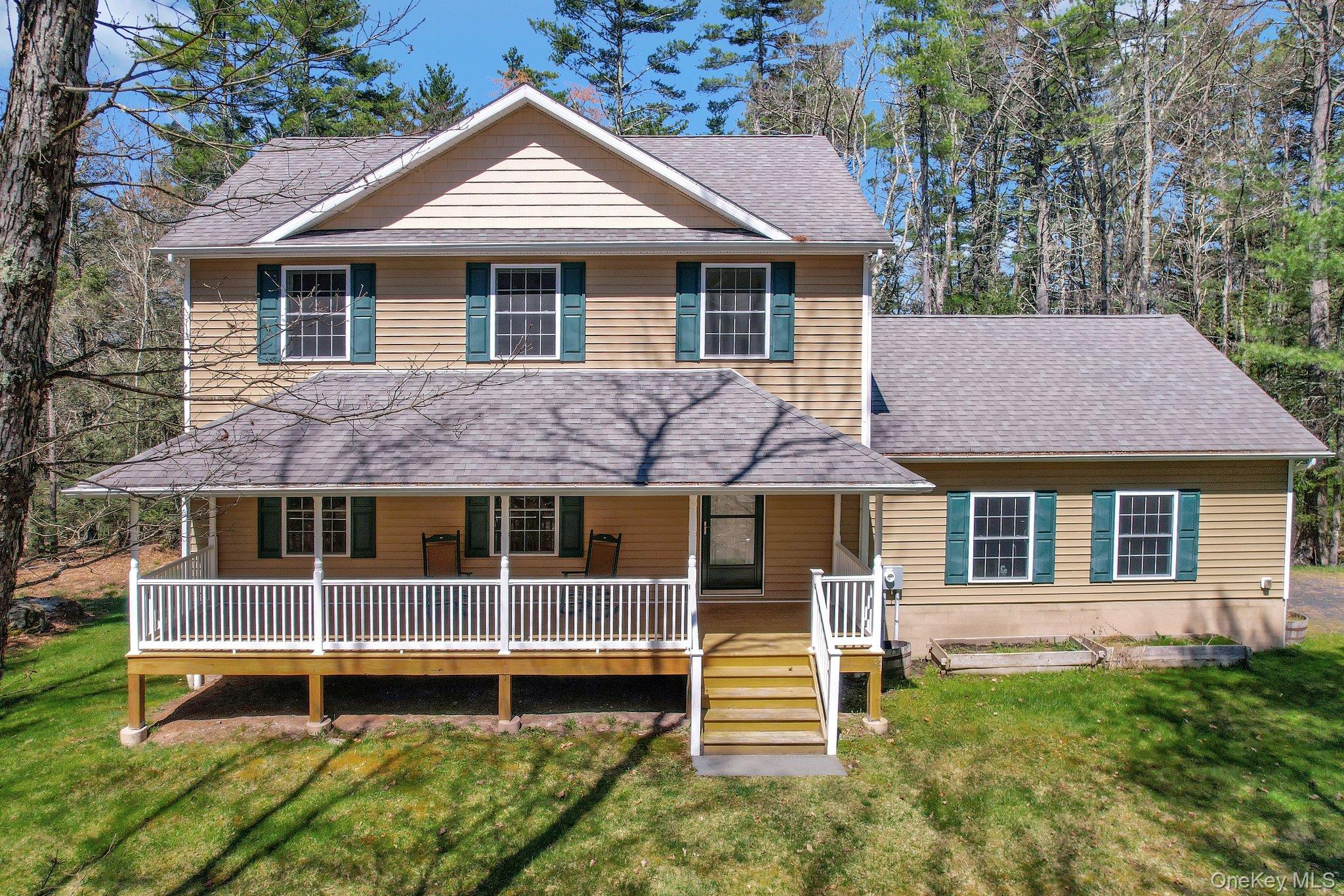 a backyard of a house with deck and outdoor seating