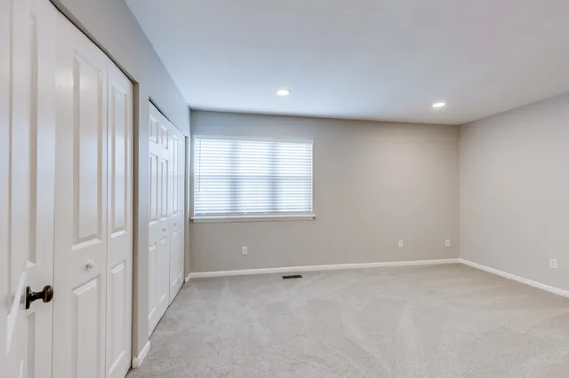 a view of a livingroom with an empty space and a window