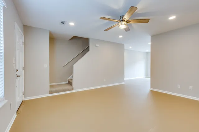 a view of an empty room with a ceiling fan