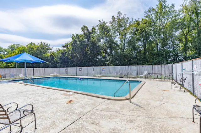 an outdoor space with pool and furniture