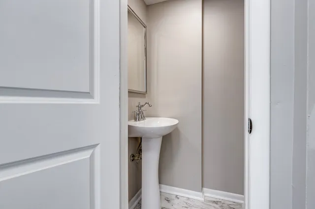 a bathroom with a sink a mirror and a toilet