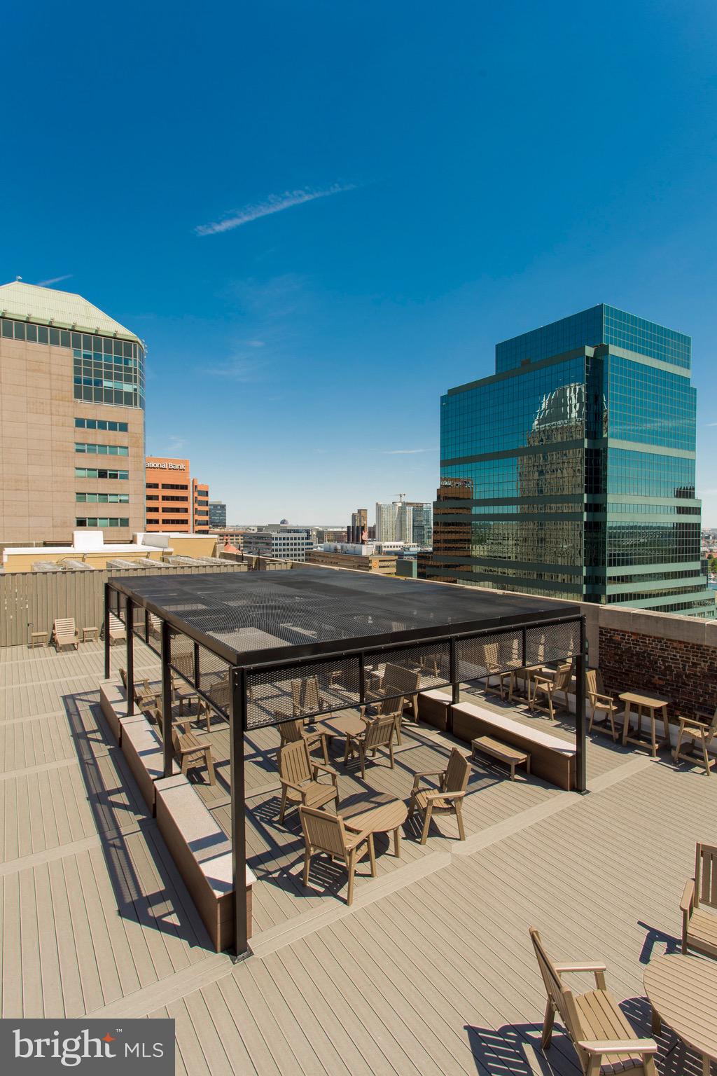 26 South Calvert Street, Unit 2BR Baltimore, MD 21202 - Photo 12 of 83 a roof deck with a wooden floor and seating space