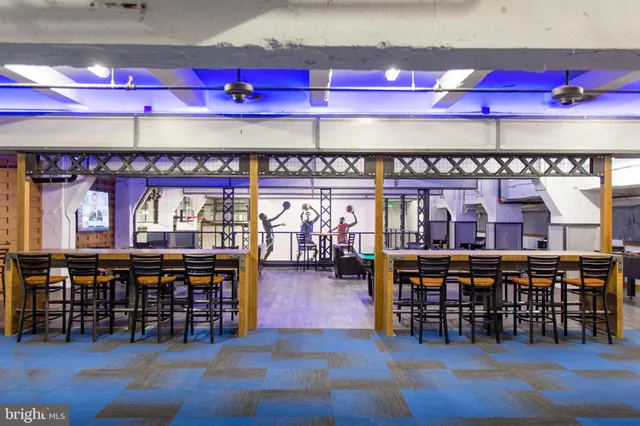 a room with furniture a rug and white walls