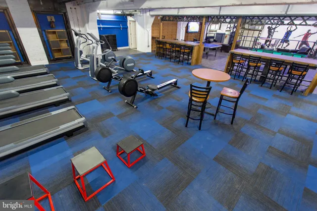 a view of a dining room with furniture and a chandelier