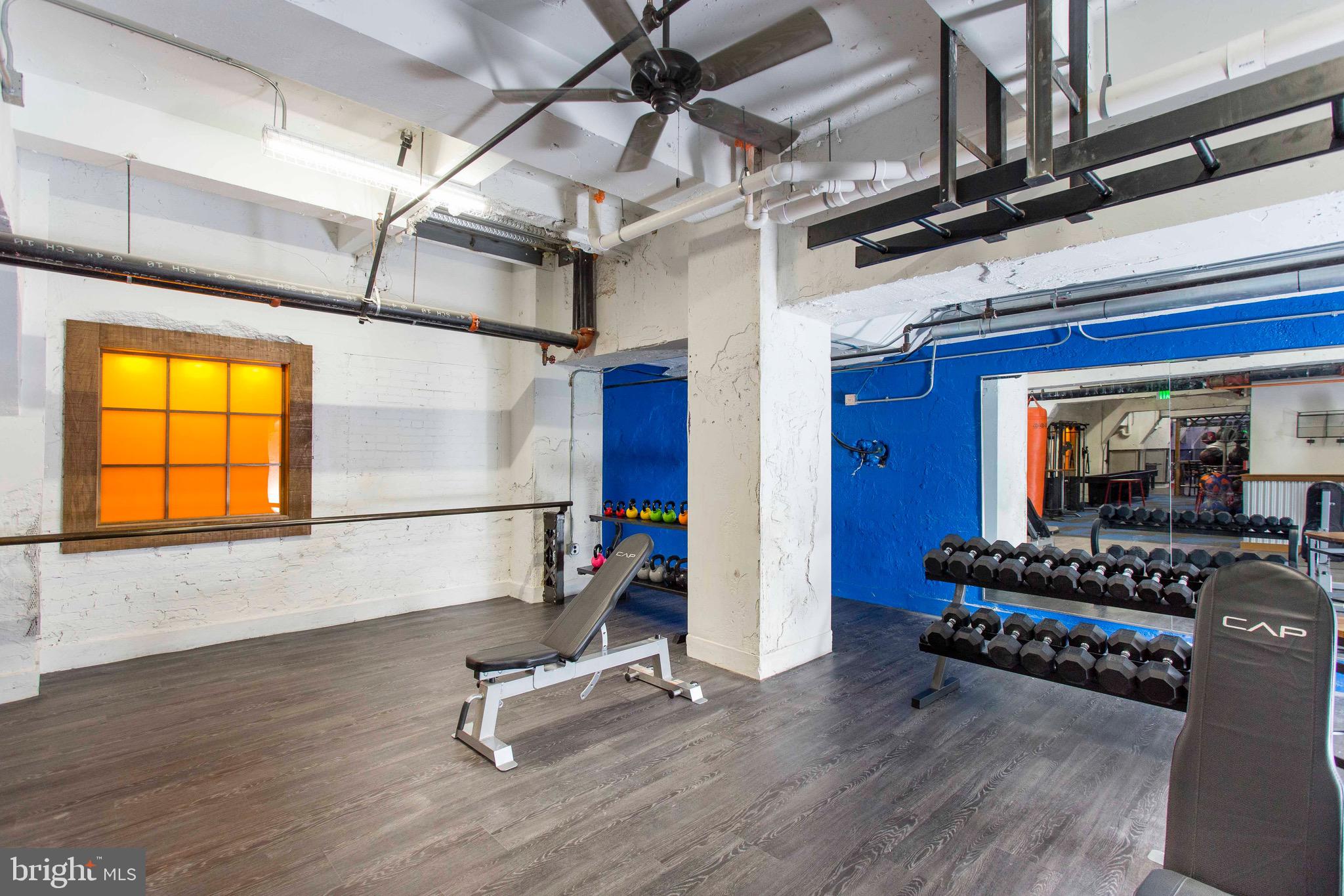 26 South Calvert Street, Unit 2BR Baltimore, MD 21202 - Photo 45 of 83 a room with gym equipment and wooden floor