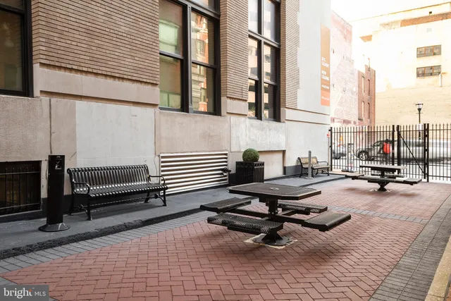 a roof deck with a wooden floor and seating space