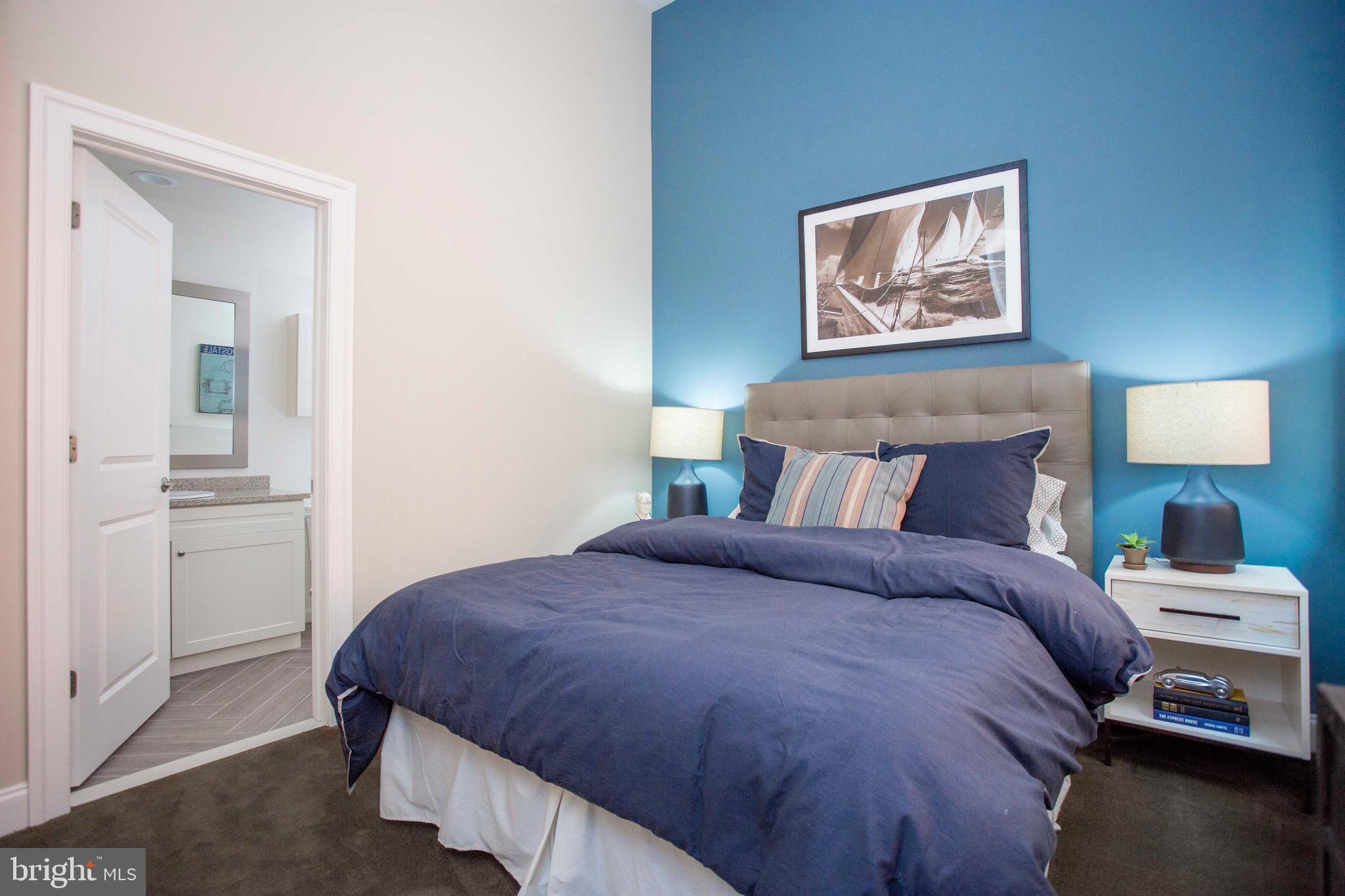 26 South Calvert Street, Unit 2BR Baltimore, MD 21202 - Photo 58 of 83 a bedroom with a bed and a lamp