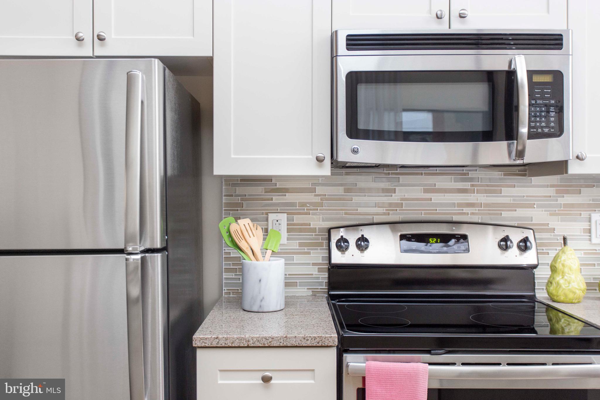 26 South Calvert Street, Unit 2BR Baltimore, MD 21202 - Photo 76 of 83 a stove top oven sitting inside of a kitchen