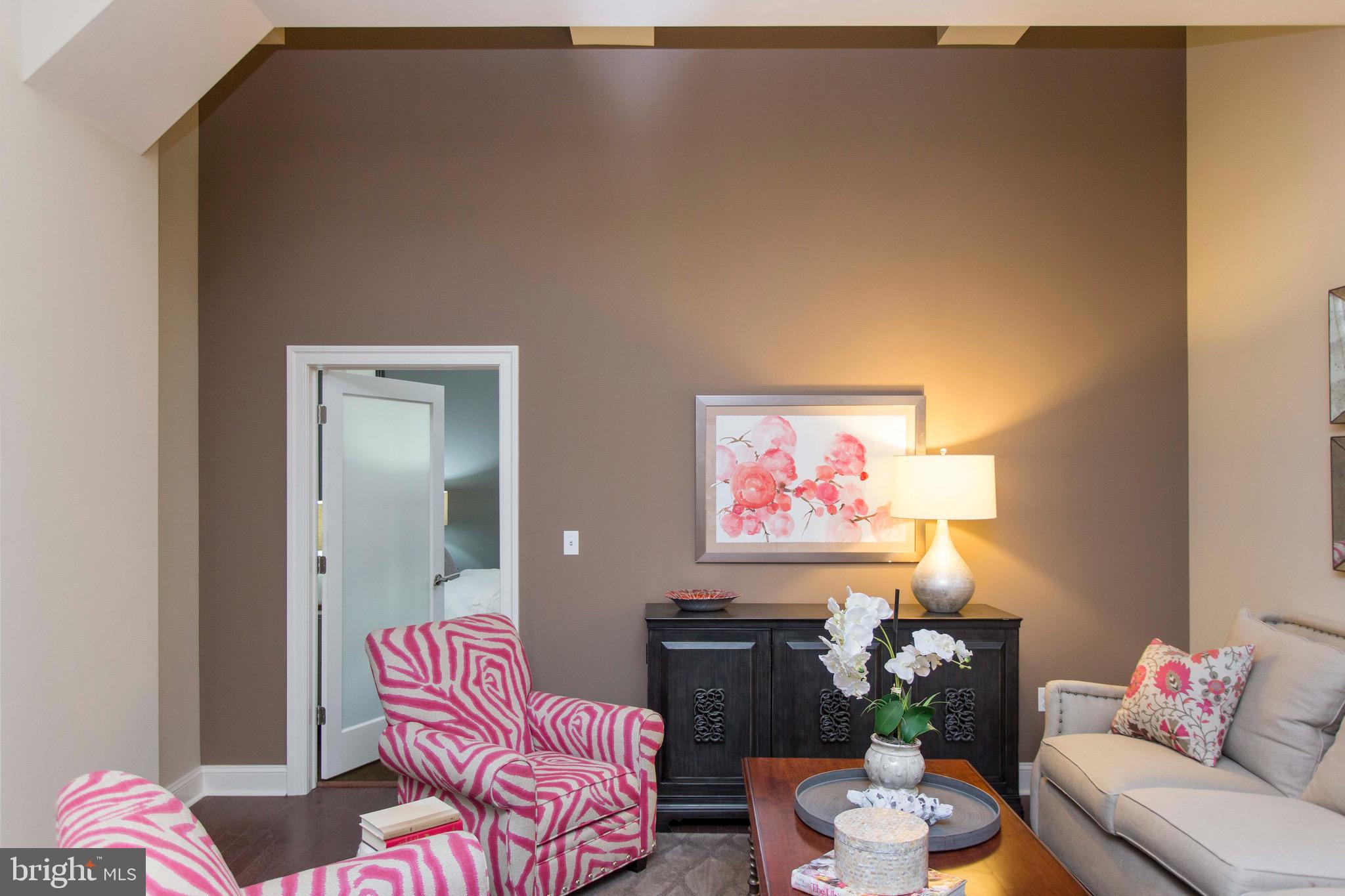 26 South Calvert Street, Unit 2BR Baltimore, MD 21202 - Photo 79 of 83 a living room with furniture and a potted plant
