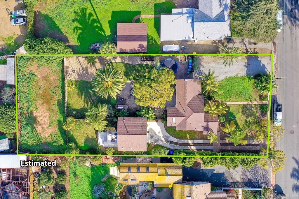 an aerial view of residential houses with outdoor space and street view