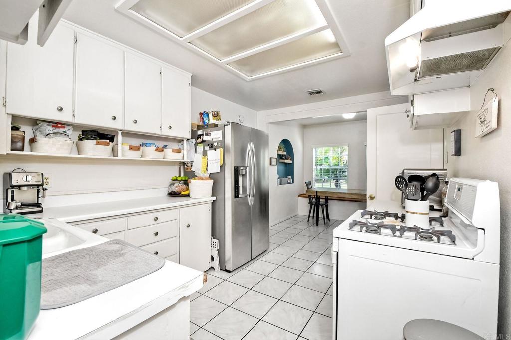1328 Pine Avenue Carlsbad, CA 92008 - Photo 12 of 48 a kitchen with kitchen island a stove a refrigerator and a sink