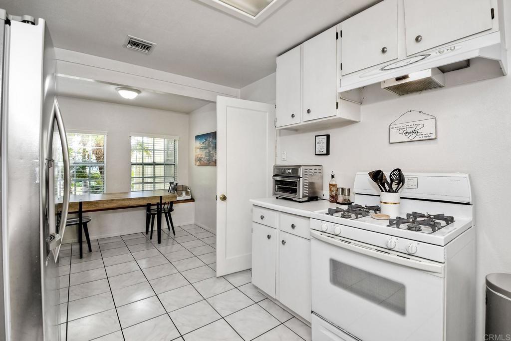 1328 Pine Avenue Carlsbad, CA 92008 - Photo 13 of 48 a kitchen with cabinets appliances a sink and a stove
