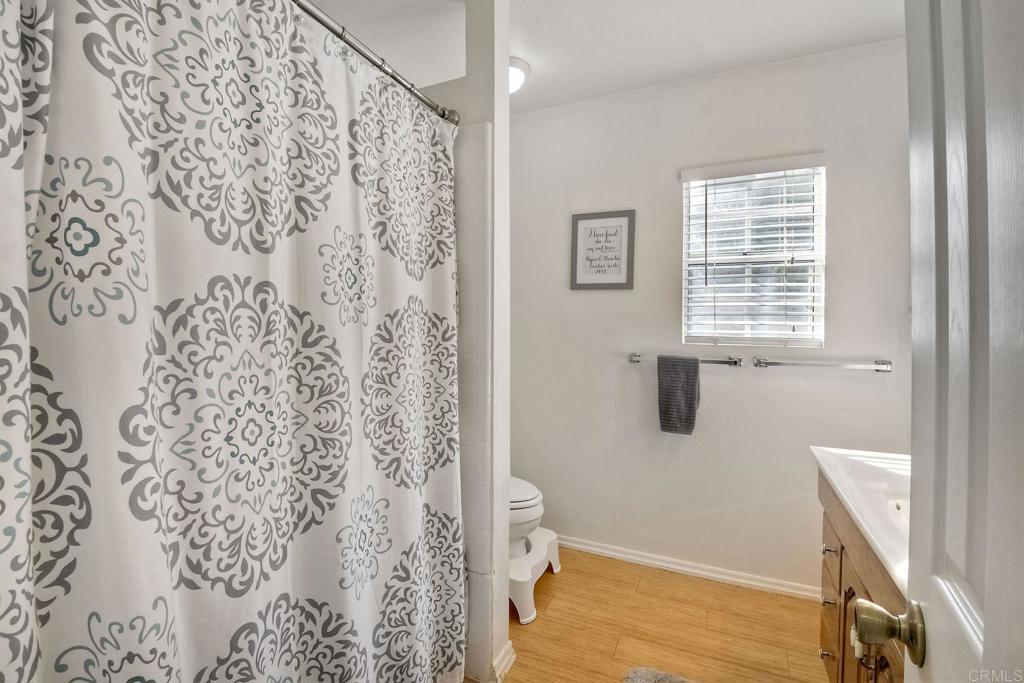 1328 Pine Avenue Carlsbad, CA 92008 - Photo 15 of 48 a bathroom with a shower curtain and a window