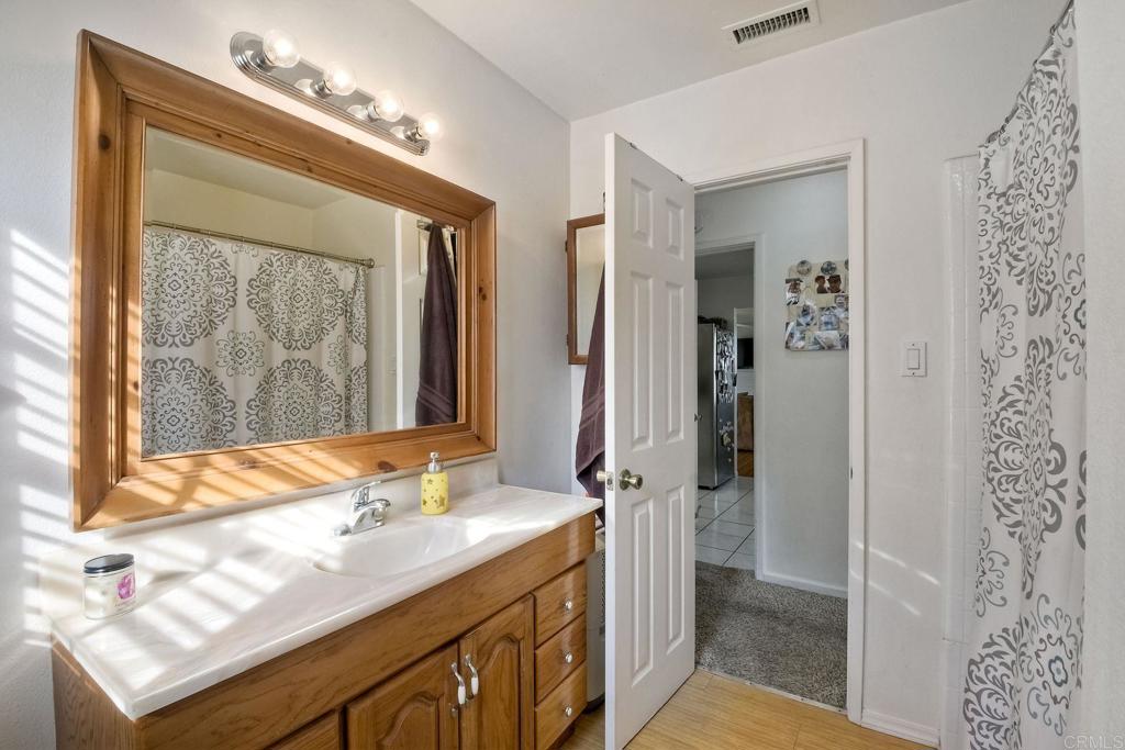 1328 Pine Avenue Carlsbad, CA 92008 - Photo 16 of 48 a bathroom with a sink double vanity and a mirror