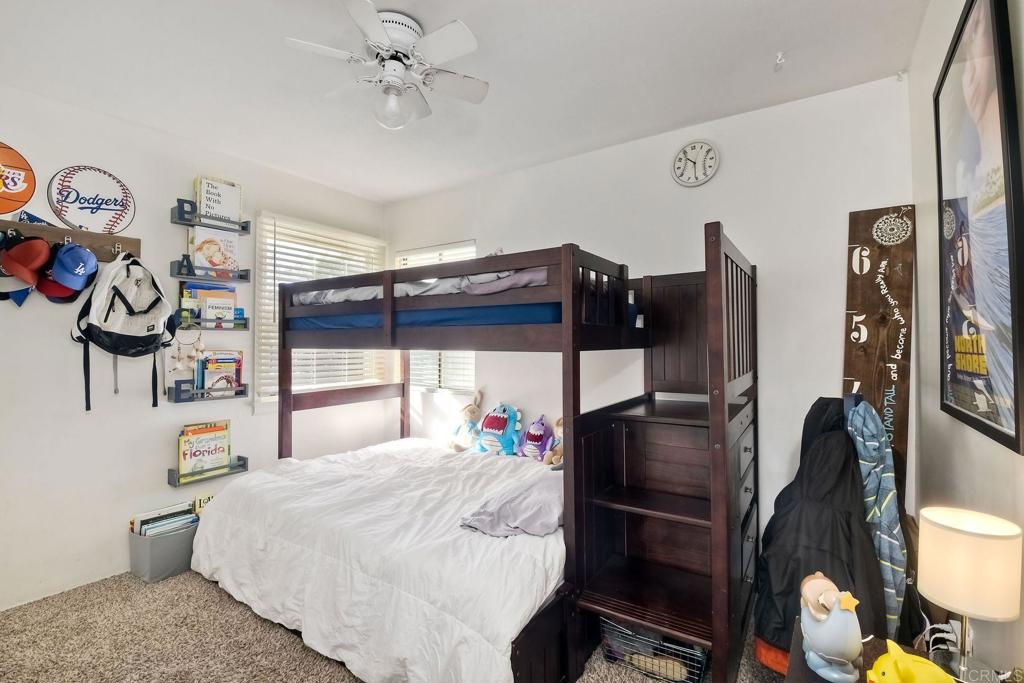 1328 Pine Avenue Carlsbad, CA 92008 - Photo 17 of 48 a bedroom with a bed and dresser with wooden floor