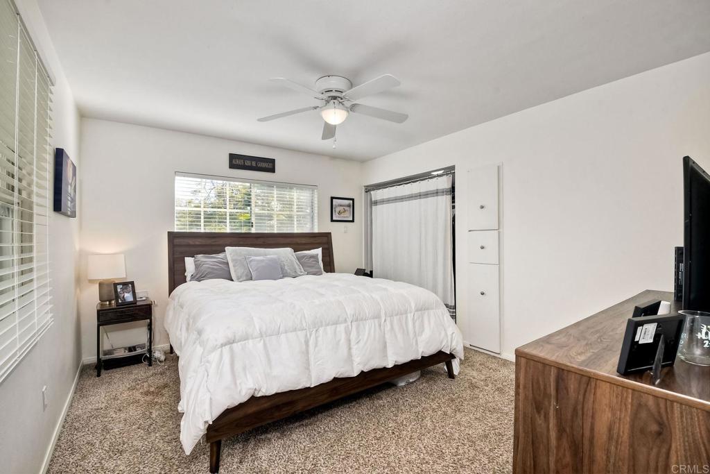 1328 Pine Avenue Carlsbad, CA 92008 - Photo 18 of 48 a bedroom with a bed and a flat tv screen on dresser