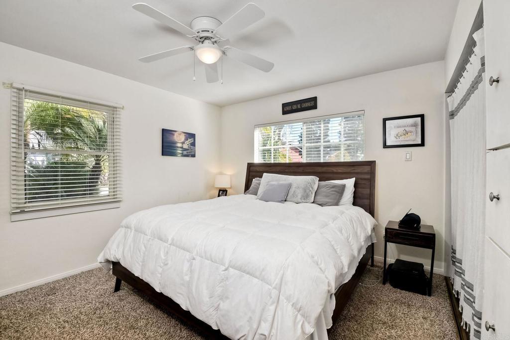 1328 Pine Avenue Carlsbad, CA 92008 - Photo 19 of 48 a bedroom with a large bed and a chandelier