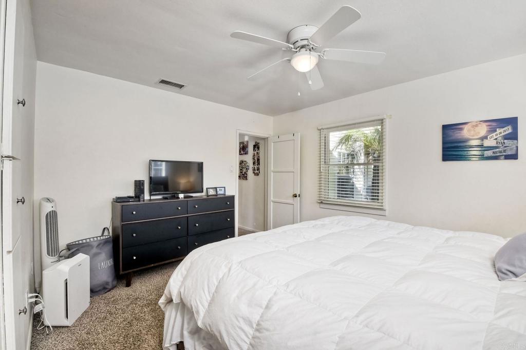 1328 Pine Avenue Carlsbad, CA 92008 - Photo 20 of 48 a bedroom with a bed a dresser and flat screen tv