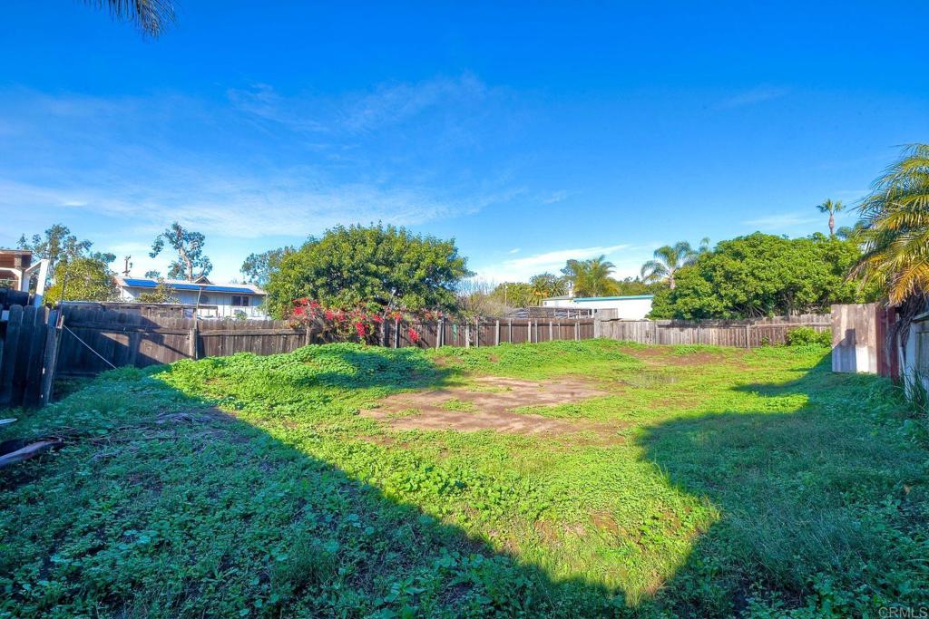 1328 Pine Avenue Carlsbad, CA 92008 - Photo 25 of 48 a view of a garden with a building in the background