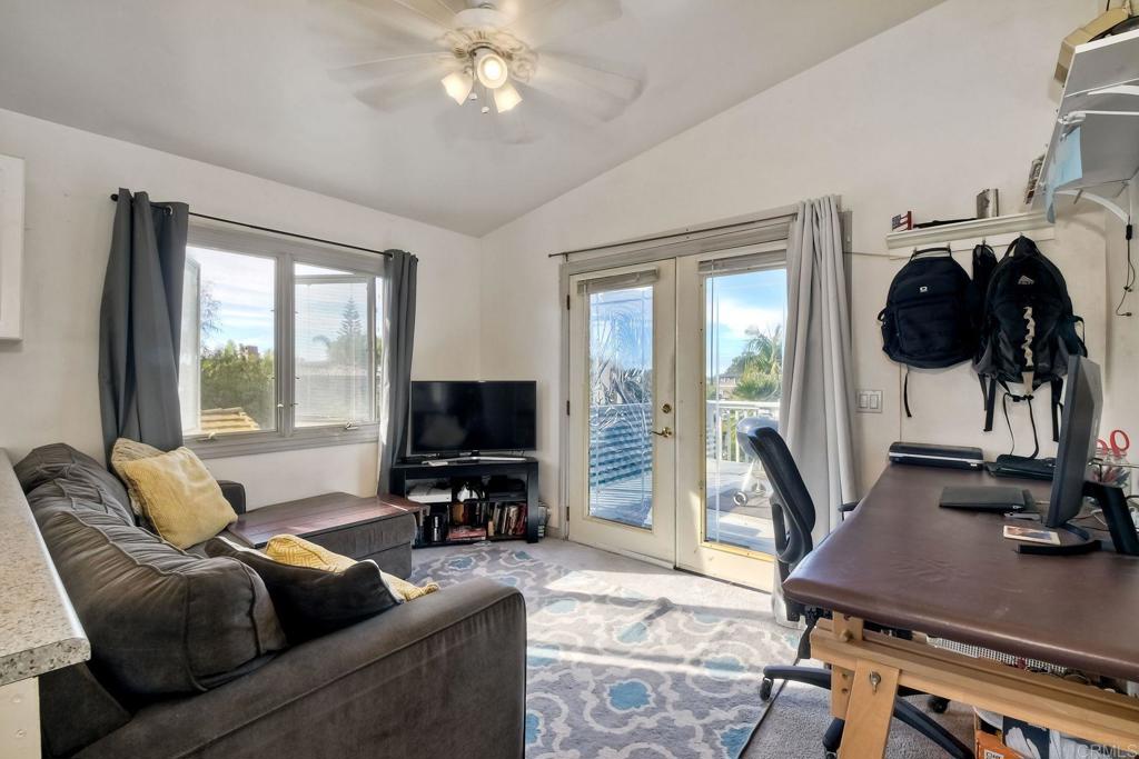 1328 Pine Avenue Carlsbad, CA 92008 - Photo 28 of 48 a living room with furniture and a flat screen tv