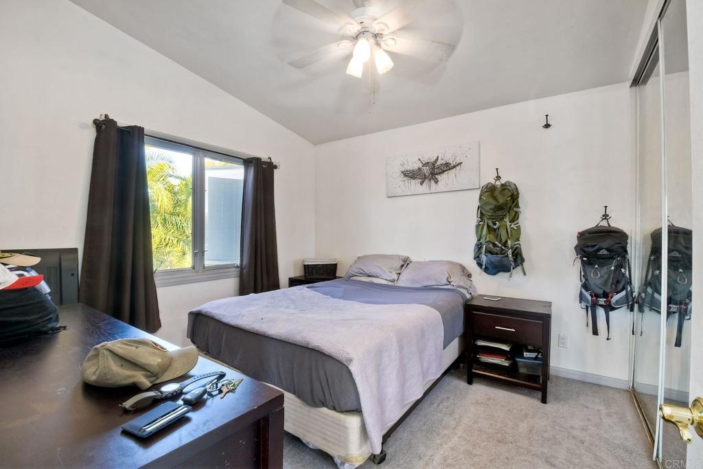 1328 Pine Avenue Carlsbad, CA 92008 - Photo 32 of 48 a bedroom with a bed and a chandelier