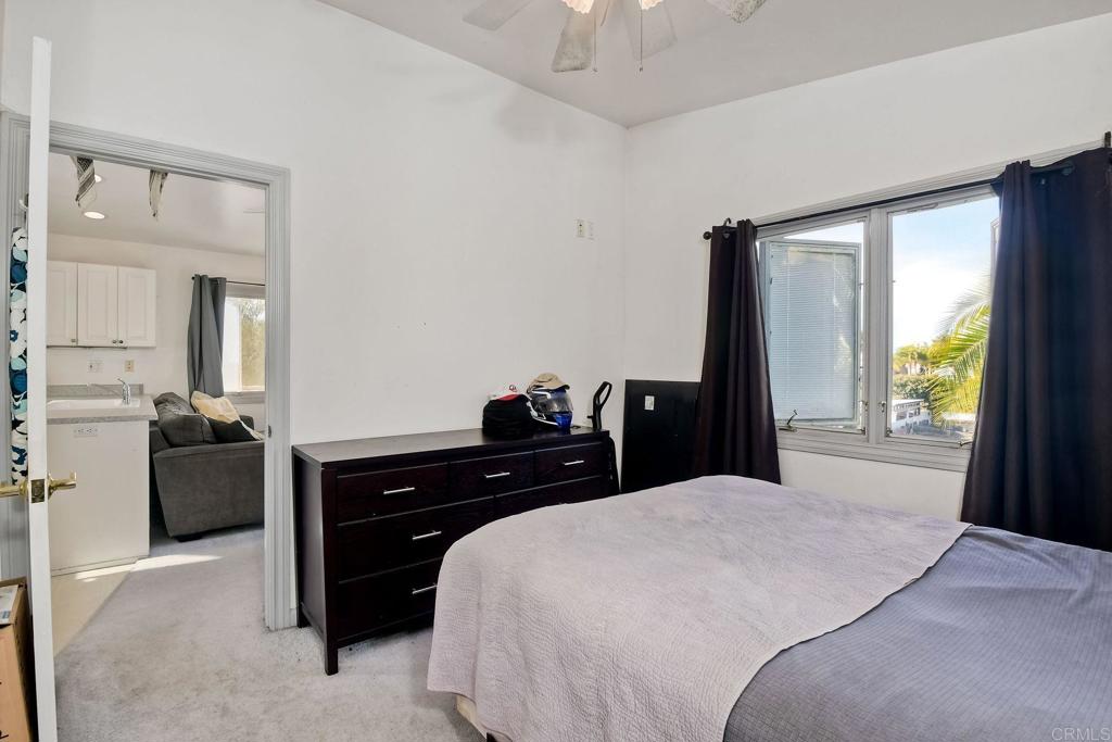 1328 Pine Avenue Carlsbad, CA 92008 - Photo 33 of 48 a bedroom with a bed and a large mirror