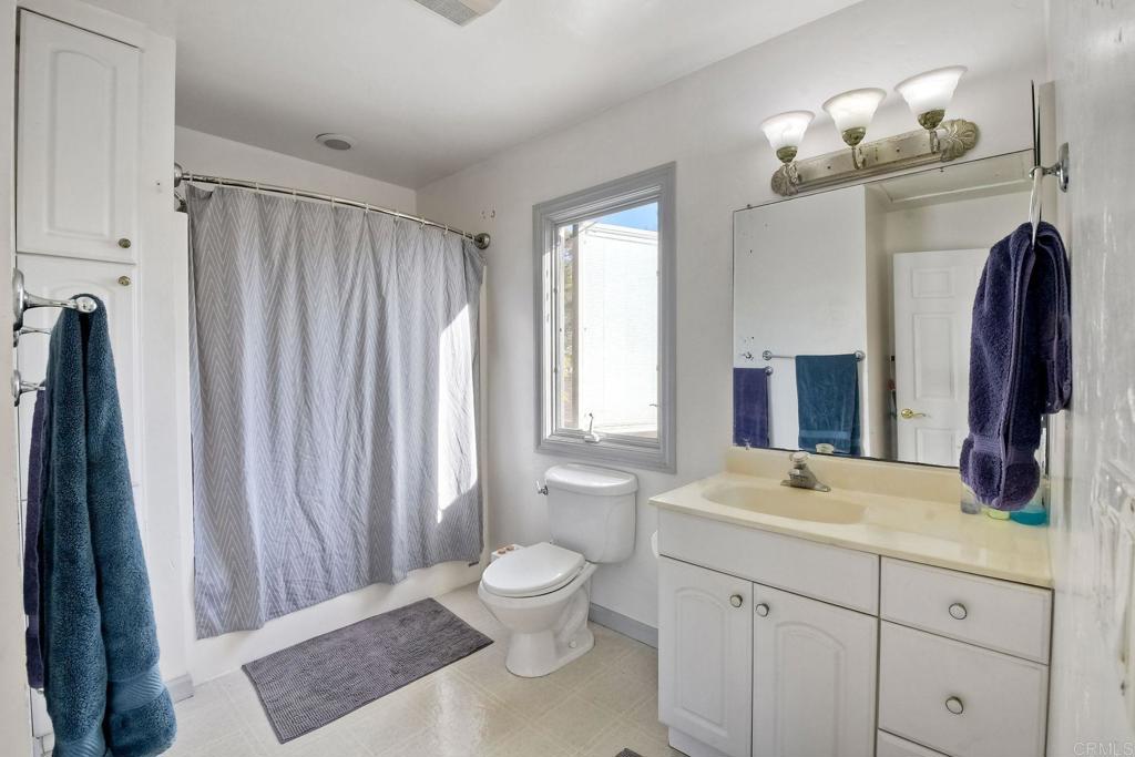 1328 Pine Avenue Carlsbad, CA 92008 - Photo 34 of 48 a bathroom with a double vanity sink and a mirror