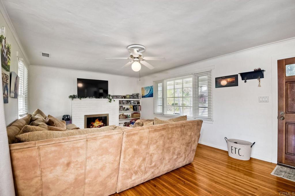 1328 Pine Avenue Carlsbad, CA 92008 - Photo 5 of 48 a living room with furniture and a flat screen tv