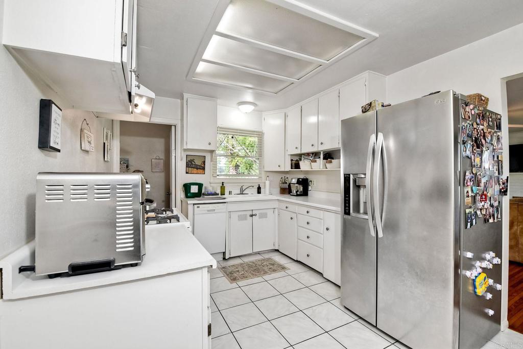 1328 Pine Avenue Carlsbad, CA 92008 - Photo 10 of 48 a kitchen with a refrigerator sink and cabinets