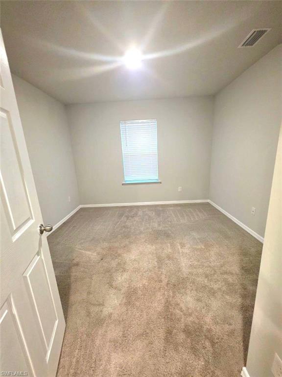 3002 37th Street Southwest Lehigh Acres, FL 33976 - Photo 4 of 11 an empty room with a fireplace