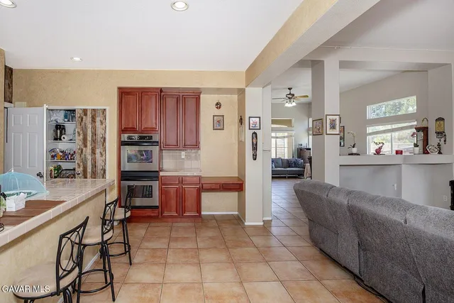 a large kitchen with a table and chairs