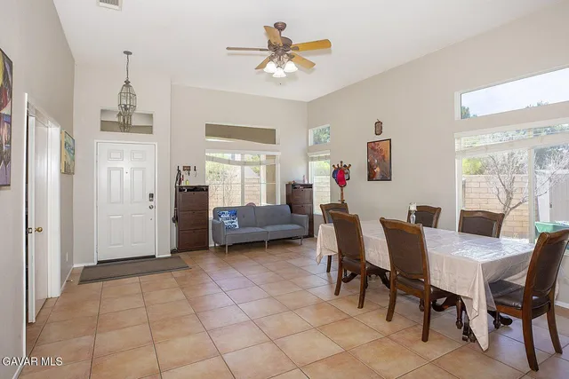 a view of a livingroom with furniture and a ceiling fan