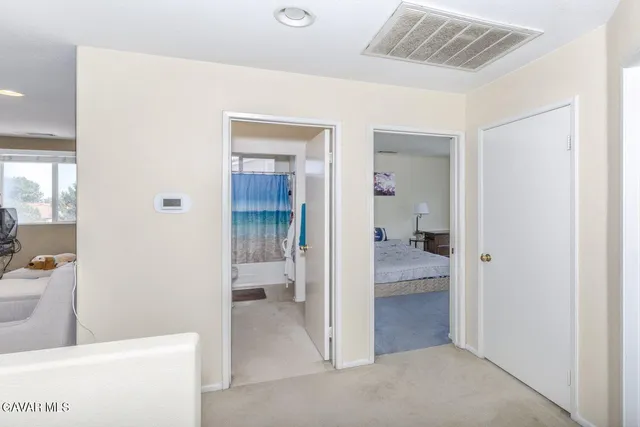 a view of a hallway with bathroom and bathroom