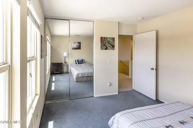 a view of a bedroom with furniture and front door