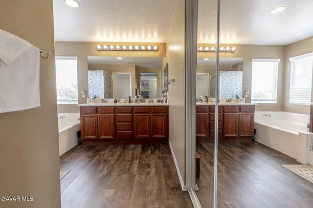 a large bathroom with a large tub and sink