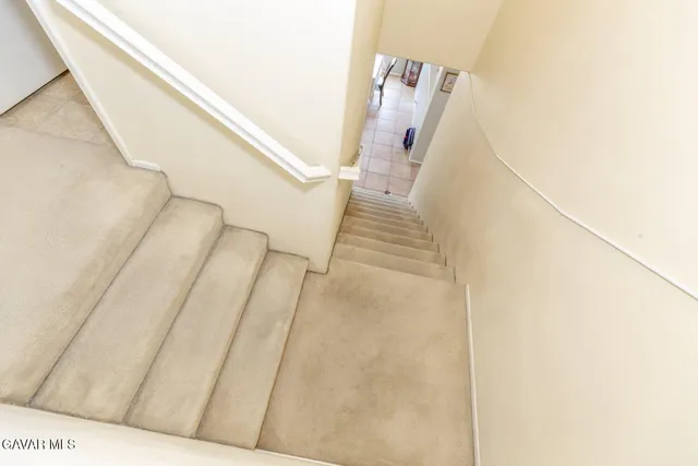 a view of staircase with white walls and a stairs