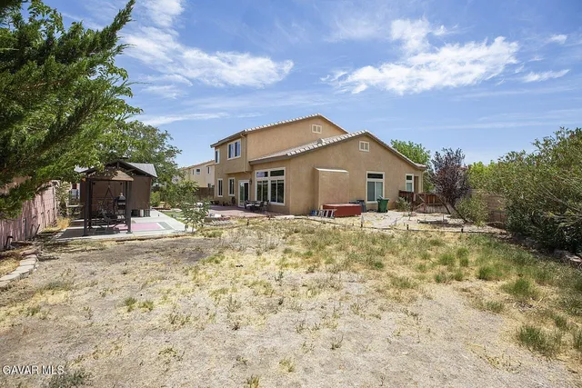 a view of a house with backyard sitting area and porch