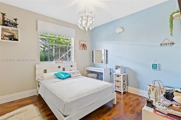 a bedroom with a bed a table and chair
