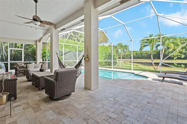 a view of living room with furniture and floor to ceiling windows